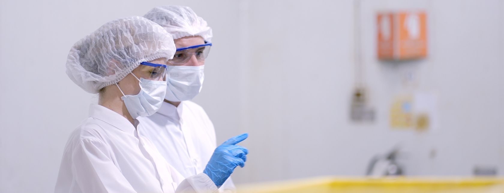 Production line worker in white sterile uniforms prevent contamination